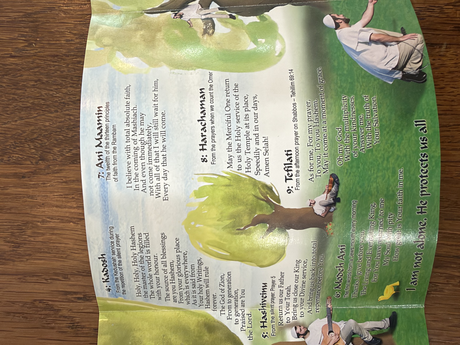 Booklet spread with Hebrew lyrics and yellow birds in a watercolor meadow